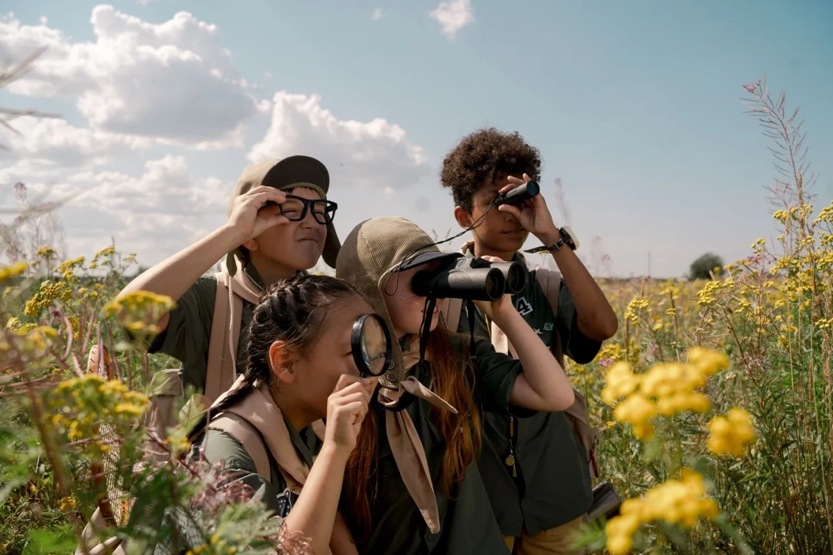 Children observing nature with binoculars