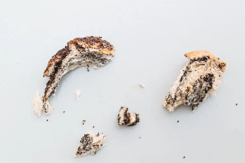 Leftover bread pieces and crumbs on a kitchen surface